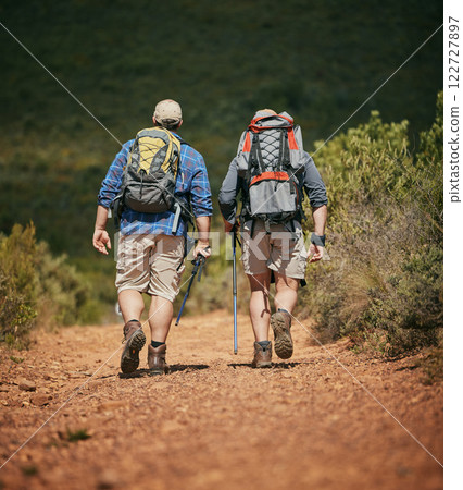 Friends trekking nature while hiking in a forest together, being active and bonding outdoors. Active male travel on a path in the woods, enjoying a physical challenge while on trekking adventure Friends trekking nature while hiking in a forest together, being active and bonding outdoors. Active male travel on a path in the woods, enjoying a physical challenge while on trekking adventure 122727897