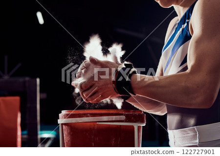 Gym, fitness and training, chalk on hands for weight lifting or cross bar gymnastics. Motivation and wellness, a strong man with muscles. Magnesium dust to support workout, strength to win. Gym, fitness and training, chalk on hands for weight lifting or cross bar gymnastics. Motivation and wellness, a strong man with muscles. Magnesium dust to support workout, strength to win. 122727901