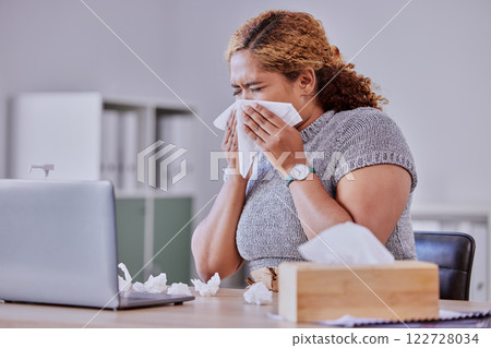 flu, covid and sick corporate employee suffering with a cold or flu, working on laptop, blow nose or sneezing in an office. Young assistant experience allergy, sinus, illness or disease symptoms 122728034