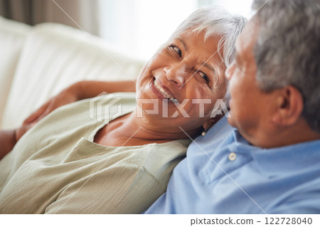 Happy, love and smile senior couple hugging relax and sitting on a couch at home. Man and woman lovers smiling and enjoying quality bonding together in the living room and having fun in the house Happy, love and smile senior couple hugging relax and sitting on a couch at home. Man and woman lovers smiling and enjoying quality bonding together in the living room and having fun in the house 122728040