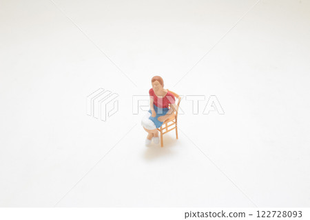 Small Figure of a Woman Sitting on a Chair Small Figure of a Woman Sitting on a Chair 122728093
