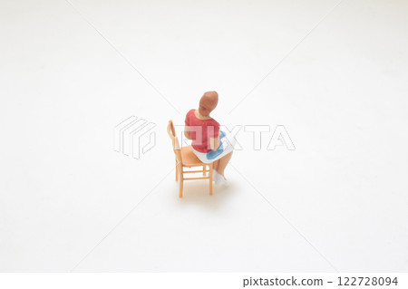 Small Figure of a Woman Sitting on a Chair Small Figure of a Woman Sitting on a Chair 122728094