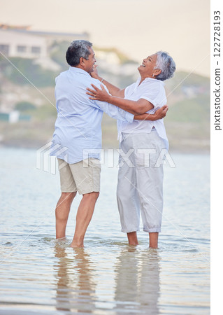 Beach dance, senior couple and comic man and woman standing in sea or ocean water and hugging at sunset. Happy, smile and bonding for marriage anniversary and love while dancing in nature with trust Beach dance, senior couple and comic man and woman standing in sea or ocean water and hugging at sunset. Happy, smile and bonding for marriage anniversary and love while dancing in nature with trust 122728193