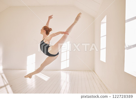 Ballet, jump and performance dance studio with young student. Dancer girl with energy in isolated classroom and moving in the air. Beautiful woman ballerina with strong body and stunning posture. 122728389