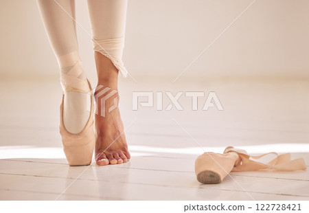 Ballet, dance and toe shoes with a ballerina or creative artist standing on a floor of a dancing studio. Performer, training and practice with a woman in rehearsal for a recital, performance or show 122728421