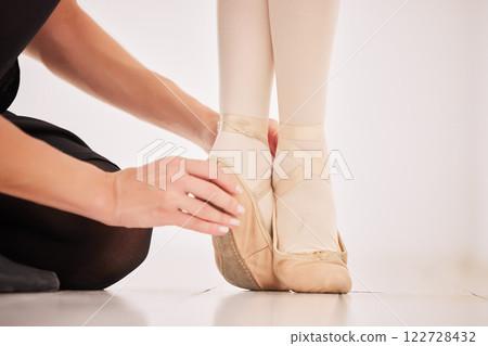 Ballet shoes, feet and learning from her dance coach or instructor about balance on tip toes in hall or studio. Education, motivation and commitment to art teacher and girl ballerina student legs Ballet shoes, feet and learning from her dance coach or instructor about balance on tip toes in hall or studio. Education, motivation and commitment to art teacher and girl ballerina student legs 122728432