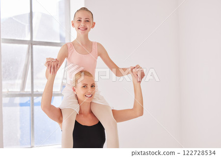 Portrait of ballet teacher carrying girl student with smile in a dance classroom or studio. Woman and young ballerina having fun after learning, training and practice dancing in a theater together 122728534