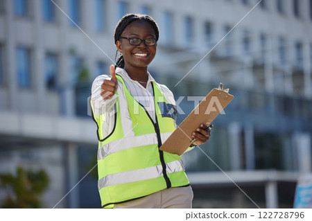 Thumbs up, success and motivation by health and safety construction worker thank you for support of goal or vision. Happy black woman holding building inspection list, showing winning, trust sign Thumbs up, success and motivation by health and safety construction worker thank you for support of goal or vision. Happy black woman holding building inspection list, showing winning, trust sign 122728796