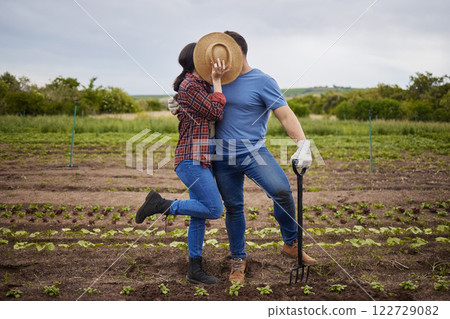 Couple kiss, agriculture farmer or garden worker on countryside field, sustainability nature or growth landscape. Bonding, romantic and fun man and woman working with environment plant and earth soil Couple kiss, agriculture farmer or garden worker on countryside field, sustainability nature or growth landscape. Bonding, romantic and fun man and woman working with environment plant and earth soil 122729082