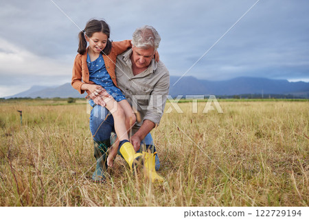 Happy family bonding on farm grandparent and girl having fun in nature, prepare for walk together. Smiling child and caring grandfather exploring outdoors, enjoying a walk in the countryside or field 122729194