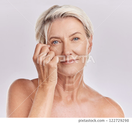 Skincare, health and hair care with a senior woman in studio on a grey background for beauty, skin care and makeup. Face portrait of a happy and healthy model with beautiful and natural hairstyle 122729298