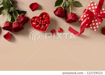 Valentine's day frame gift, red roses and candy sweets as heart on beige. Valentine's day frame gift, red roses and candy sweets as heart on beige. 122729523