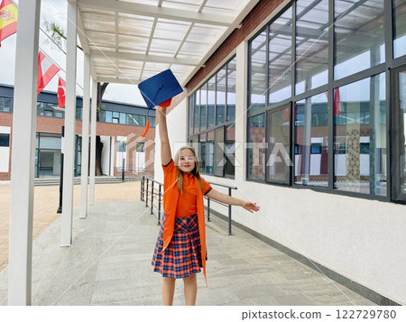 Portrait of cheerful cute schoolgirl in school uniform junior level before going to school Portrait of cheerful cute schoolgirl in school uniform junior level before going to school 122729780