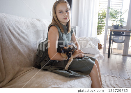 Portrait of young girl and cat pet together at home. Friendship and care 122729785