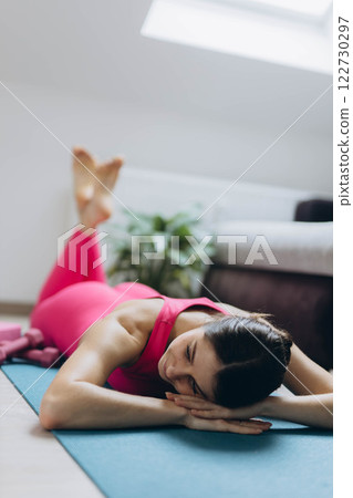 Stretching, yoga and woman on a living room floor for training, exercise or mental health at home. Legs, stretch and lady with flexible fitness or pilates workout for balance, meditation or wellness Stretching, yoga and woman on a living room floor for training, exercise or mental health at home. Legs, stretch and lady with flexible fitness or pilates workout for balance, meditation or wellness 122730297