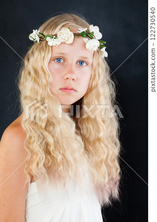 Beautiful serious child girl with long blond hair portrait 122730540