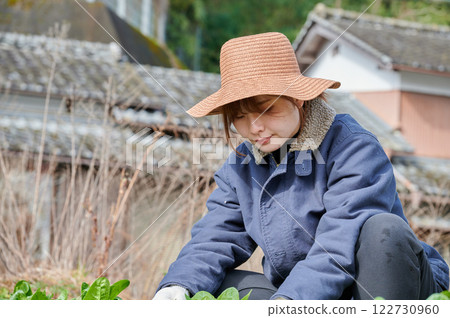 Woman working in the fields, country life, home garden 122730960