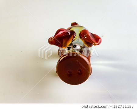 Glass figurine of a pig on a white background. Clear and red glass 122731183