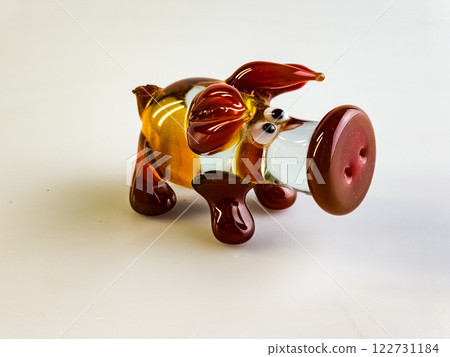 Glass figurine of a pig on a white background. Clear and red glass. Funny pig Glass figurine of a pig on a white background. Clear and red glass. Funny pig 122731184