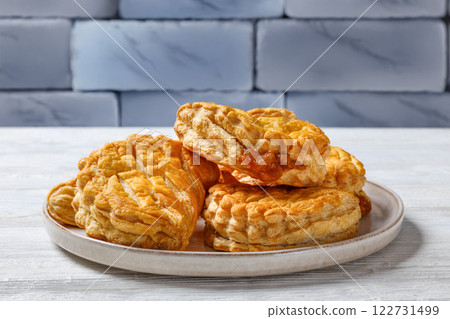 puff pastry apple turnovers on a plate 122731499