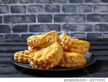 puff pastry apple turnovers on a plate 122731501
