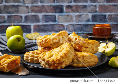 puff pastry apple turnovers on a plate 122731502