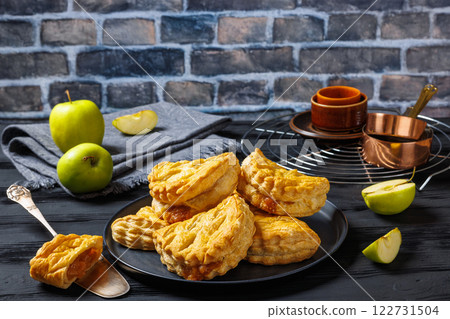 puff pastry apple turnovers on a plate 122731504