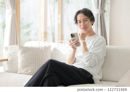 A man operating a smartphone 122731989