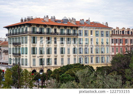 Red and orange buildings in Nice, France, park with green park trees Red and orange buildings in Nice, France, park with green park trees 122733155