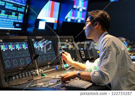 A man working at a TV station A man working at a TV station 122733287