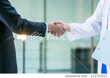 Doctors shaking hands in hospital 122733311