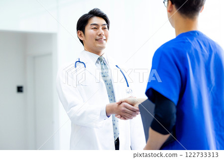 Doctors shaking hands in hospital Doctors shaking hands in hospital 122733313