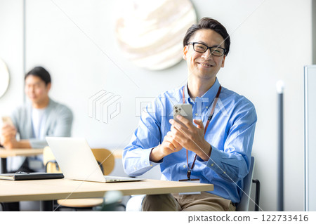 Business person who operates a smartphone Business person who operates a smartphone 122733416