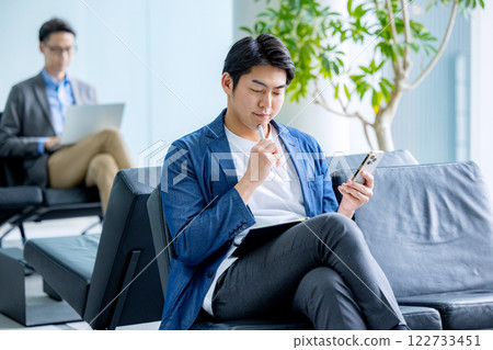 A man making a phone call while teleworking A man making a phone call while teleworking 122733451