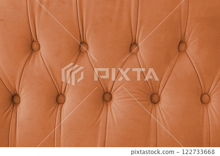 Capitone, Chesterfield style suede fabric texture, orange diamond buttoned orange background Capitone, Chesterfield style suede fabric texture, orange diamond buttoned orange background 122733668