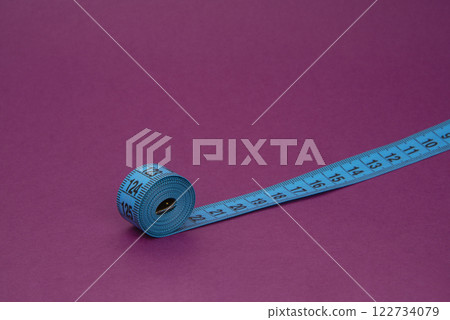 Colorful tape measure spiral with copyspace background Colorful tape measure spiral with copyspace background 122734079