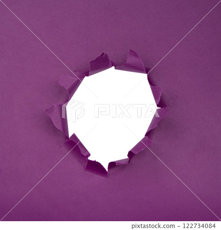 Hole in paper purple background torn damaged for design Hole in paper purple background torn damaged for design 122734084