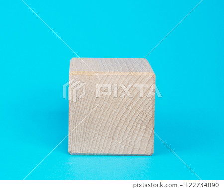 Empty clear wooden cube on blue background 122734090