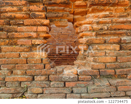 Hole in the ancient brick wall, ancient red brick texture. 122734475