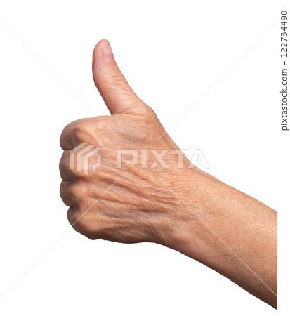 Elderly hand showing thumbs-up gesture, symbolizing approval, success, and positivity. Wrinkled skin 122734490