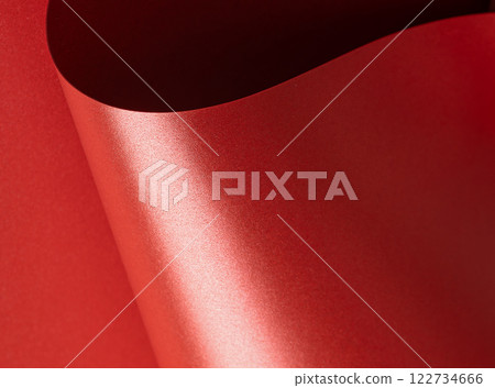 Shiny red paper with a glossy, luxurious surface and elegant sheen. Festive and textured background 122734666