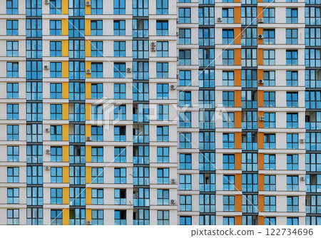 Closeup of modern residential building facades with colorful windows and stylish design. 122734696