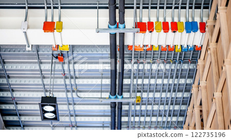 Electrical cable conduit wiring with colorful junction box on the ceiling Electrical cable conduit wiring with colorful junction box on the ceiling 122735196