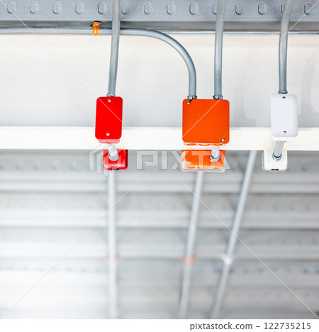Electrical cable conduit with colorful junction box on the ceiling 122735215