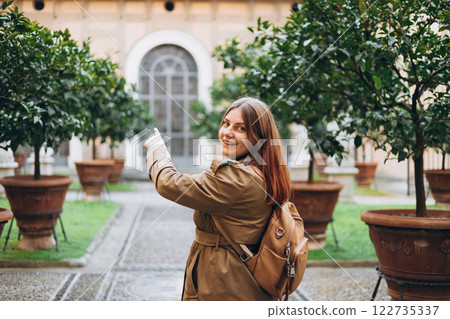 Happy 30s Woman with backpack Searching locations and pointing finger at spring day. Traveling Europe, High quality photo Happy 30s Woman with backpack Searching locations and pointing finger at spring day. Traveling Europe, High quality photo 122735337