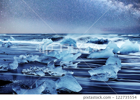Icebergs floating in Jokulsarlon glacial lake. South Iceland. Lagoon. Starry sky night. Fantastic milky way Icebergs floating in Jokulsarlon glacial lake. South Iceland. Lagoon. Starry sky night. Fantastic milky way 122735554