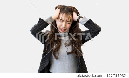 A woman/businesswoman holding her head in worry 122735982