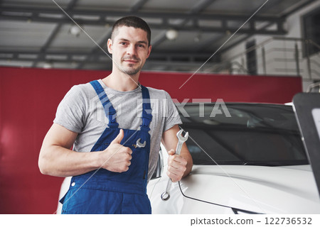 Hand of car mechanic with wrench. Auto repair garage 122736532