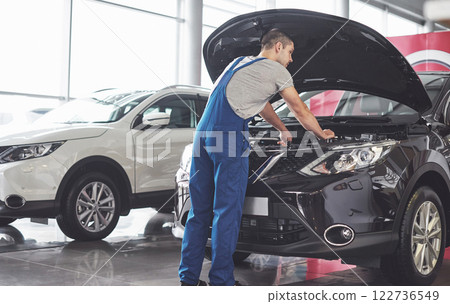 Picture showing muscular car service worker repairing vehicle 122736549