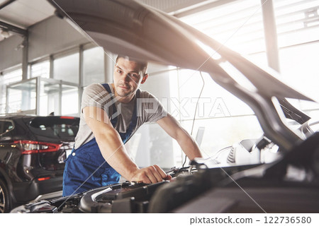 Auto mechanic working in garage. Repair service Auto mechanic working in garage. Repair service 122736580